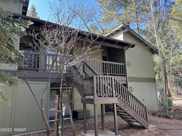 back of house with stairs