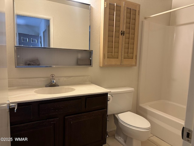 bathroom with tile patterned flooring, vanity, and toilet