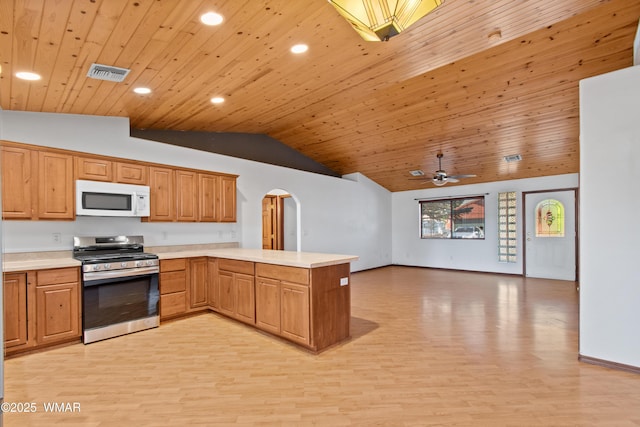 677 Fox Ln, Lakeside, AZ 85929 - kitchen with white microwave, stainless steel range with gas cooktop, vaulted ceiling, arched walkways, and wood ceiling