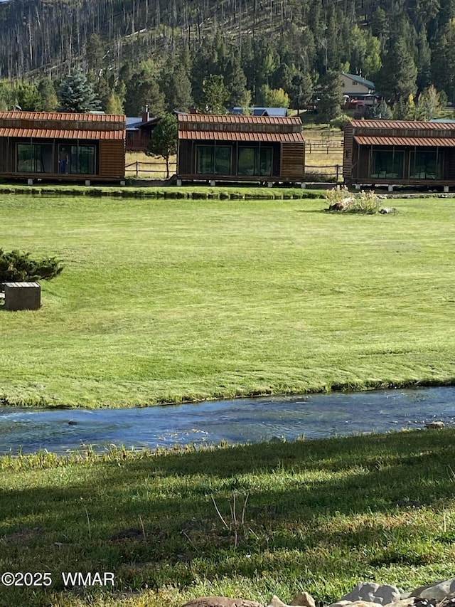 677 Fox Ln, Lakeside, AZ 85929 - view of grassy yard with a forest view, an outbuilding, and a water view