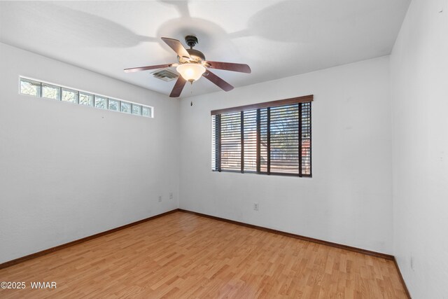 677 Fox Ln, Lakeside, AZ 85929 - unfurnished room featuring plenty of natural light, wood finished floors, ceiling fan, and baseboards