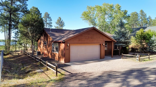 677 Fox Ln, Lakeside, AZ 85929 - view of side of property featuring driveway, an attached garage, and central AC
