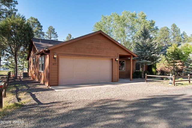 677 Fox Ln, Lakeside, AZ 85929 - chalet / cabin with a garage, gravel driveway, and central AC