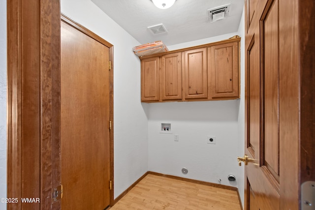 677 Fox Ln, Lakeside, AZ 85929 - laundry area with washer hookup, hookup for an electric dryer, cabinet space, light wood-type flooring, and baseboards