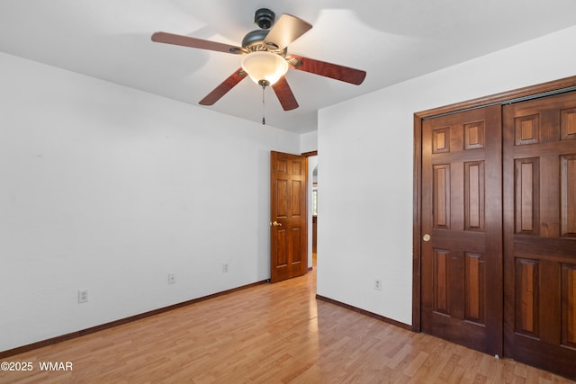 677 Fox Ln, Lakeside, AZ 85929 - unfurnished bedroom with light wood-style floors, baseboards, and a ceiling fan
