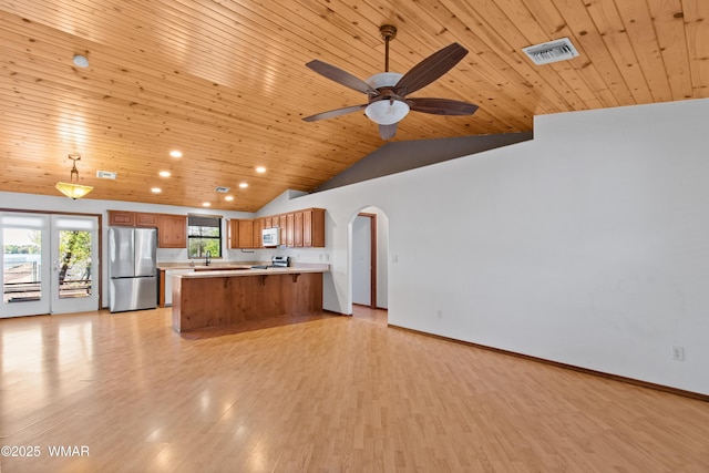 677 Fox Ln, Lakeside, AZ 85929 - kitchen with appliances with stainless steel finishes, brown cabinetry, wood ceiling, light countertops, and light wood-style floors