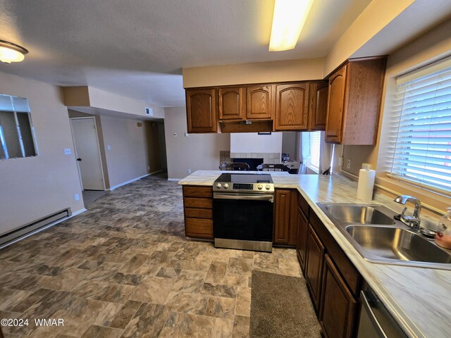 kitchen featuring dishwashing machine, a peninsula, light countertops, stainless steel range with electric stovetop, and a sink