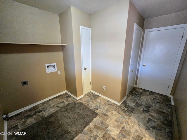 clothes washing area featuring laundry area, washer hookup, baseboards, stone finish floor, and electric dryer hookup