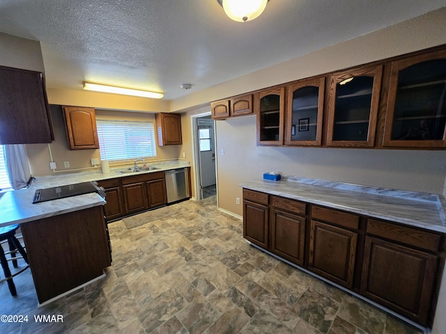 kitchen with glass insert cabinets, light countertops, a sink, and dishwasher