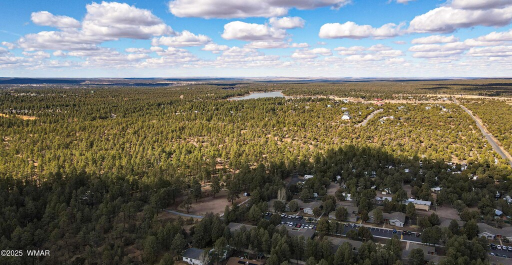 birds eye view of property featuring a view of trees