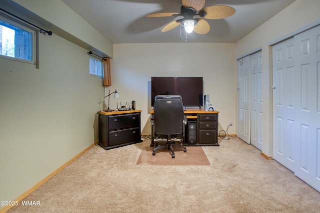 office space featuring carpet floors, a ceiling fan, and baseboards