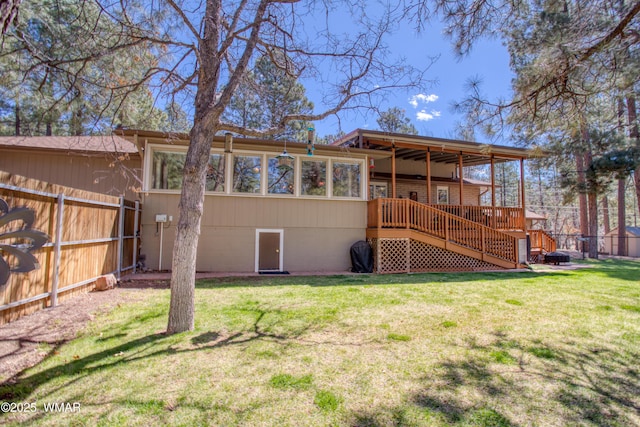 rear view of house with a lawn, a fenced backyard, and stairs