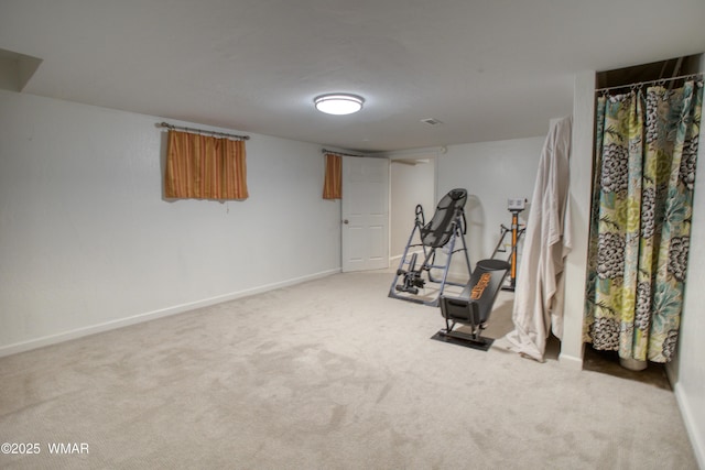 exercise room with baseboards, carpet flooring, and visible vents