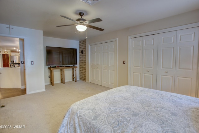 bedroom featuring multiple closets, stainless steel fridge, ceiling fan, carpet, and baseboards