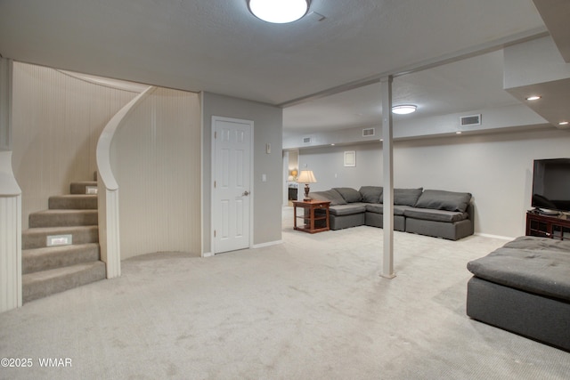 living area with stairway, carpet floors, visible vents, and baseboards