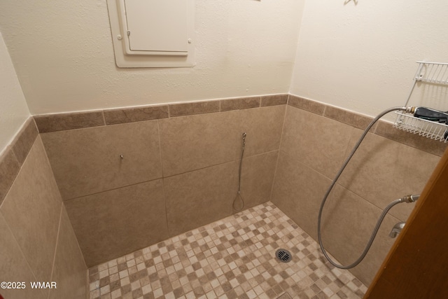 bathroom with tiled shower