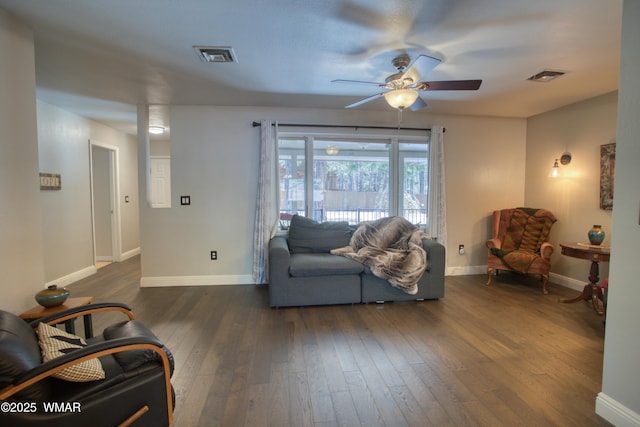 living room featuring visible vents, dark wood-style floors, and ceiling fan