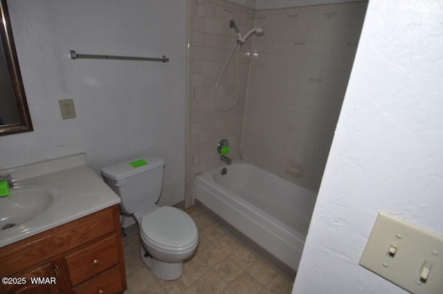 bathroom featuring toilet, vanity, and washtub / shower combination