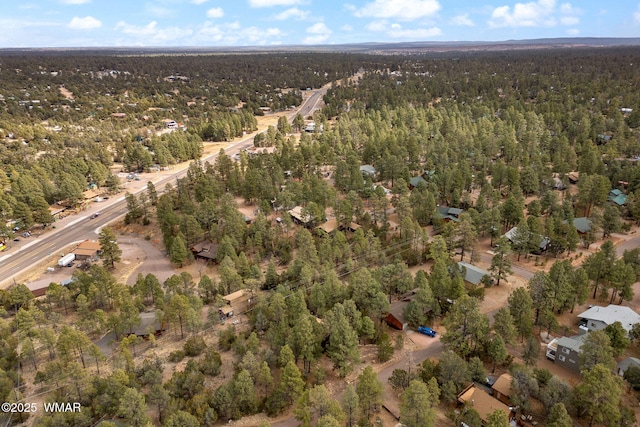 aerial view featuring a wooded view