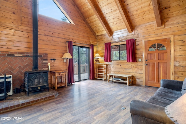 living room with a wood stove, wooden ceiling, plenty of natural light, and wooden walls