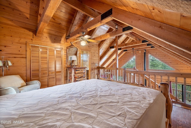 bedroom with lofted ceiling with beams, wood finished floors, wood ceiling, and wooden walls