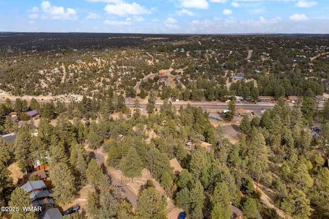 birds eye view of property with a wooded view