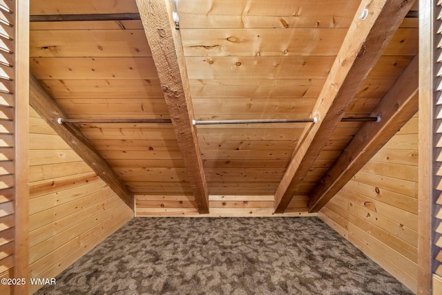 room details featuring carpet, wood ceiling, and wood walls