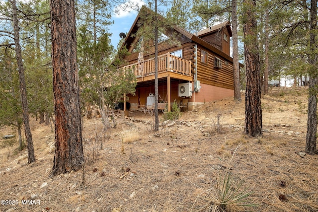 exterior space featuring log siding and a deck