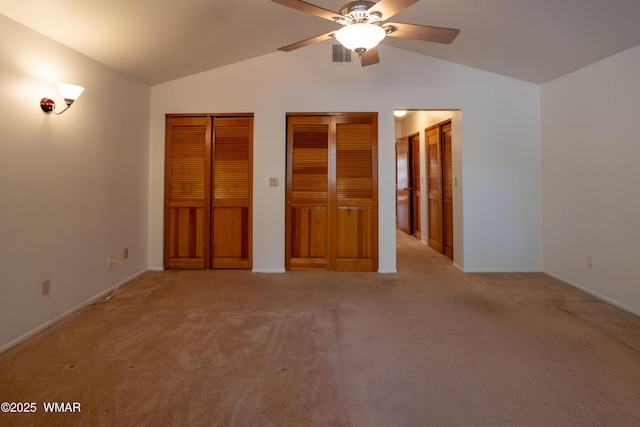 2761 Blue Lupine Ln, Pinetop, AZ 85935 - unfurnished bedroom featuring two closets, lofted ceiling, light colored carpet, and visible vents