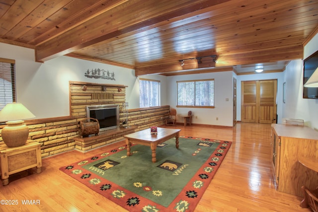 2761 Blue Lupine Ln, Pinetop, AZ 85935 - living area with crown molding, wooden ceiling, beam ceiling, light wood-style flooring, and a fireplace