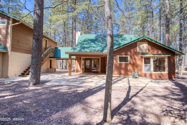 2761 Blue Lupine Ln, Pinetop, AZ 85935 - rear view of property featuring a chimney, stairs, and metal roof