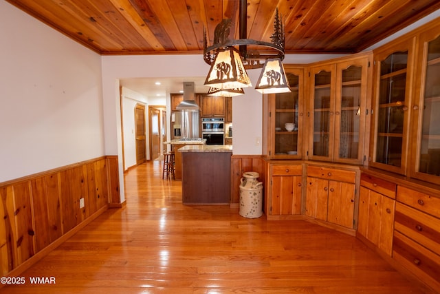 2761 Blue Lupine Ln, Pinetop, AZ 85935 - kitchen featuring island exhaust hood, wainscoting, wooden ceiling, and double oven