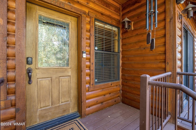 view of exterior entry with faux log siding