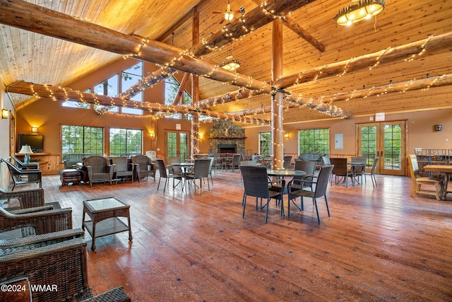 dining room featuring french doors, beam ceiling, wood ceiling, high vaulted ceiling, and wood-type flooring
