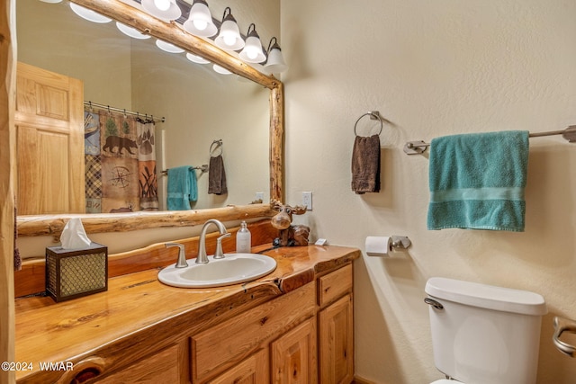full bathroom with toilet, vanity, and a shower with shower curtain