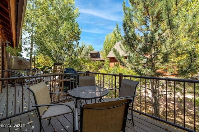 wooden terrace featuring outdoor dining space