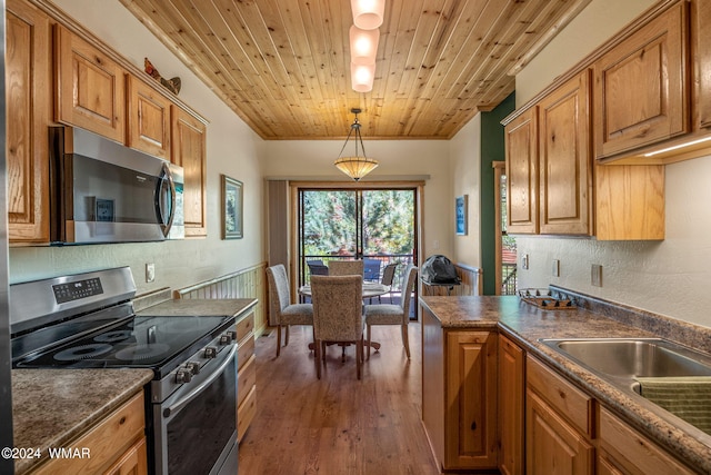 kitchen with brown cabinets and appliances with stainless steel finishes