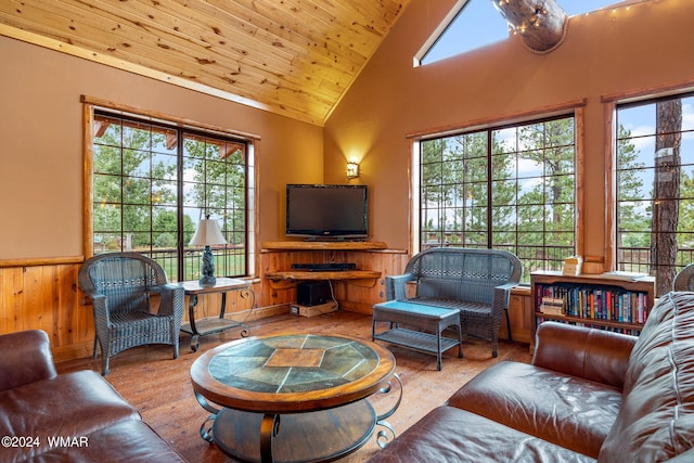 living area featuring wooden walls, wood finished floors, wooden ceiling, wainscoting, and high vaulted ceiling