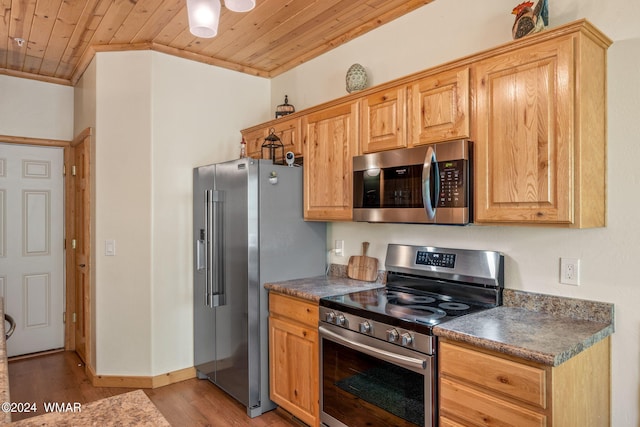 kitchen with wood ceiling, dark countertops, and appliances with stainless steel finishes