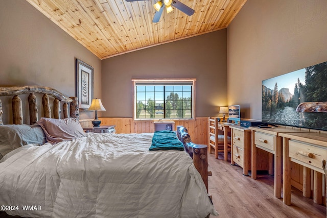 bedroom featuring vaulted ceiling, wood finished floors, a wainscoted wall, wooden ceiling, and wood walls