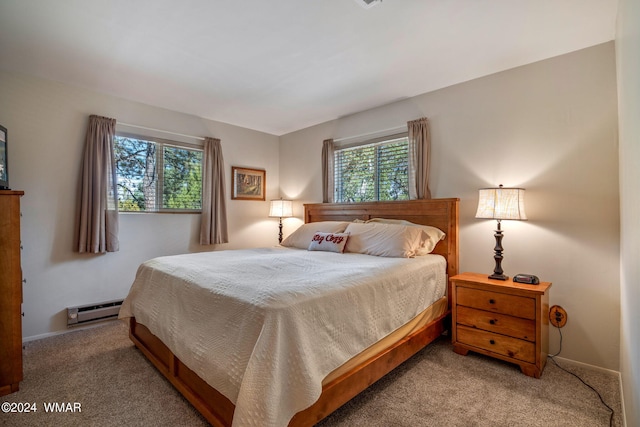 bedroom featuring carpet floors, baseboards, and baseboard heating