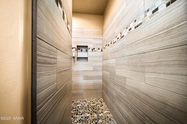 bathroom with tiled shower