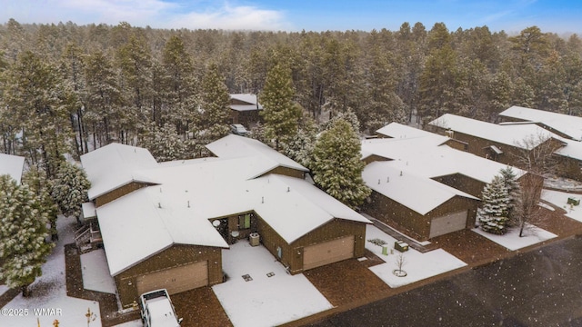 drone / aerial view featuring a forest view