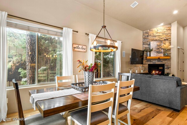 dining room with visible vents, plenty of natural light, and wood finished floors