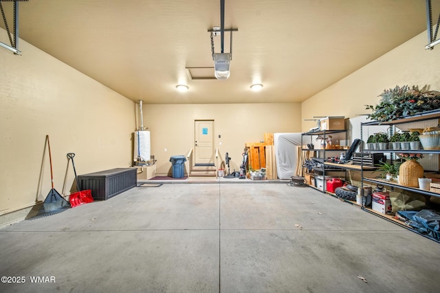 garage featuring water heater and a garage door opener