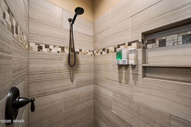 interior details featuring a tile shower