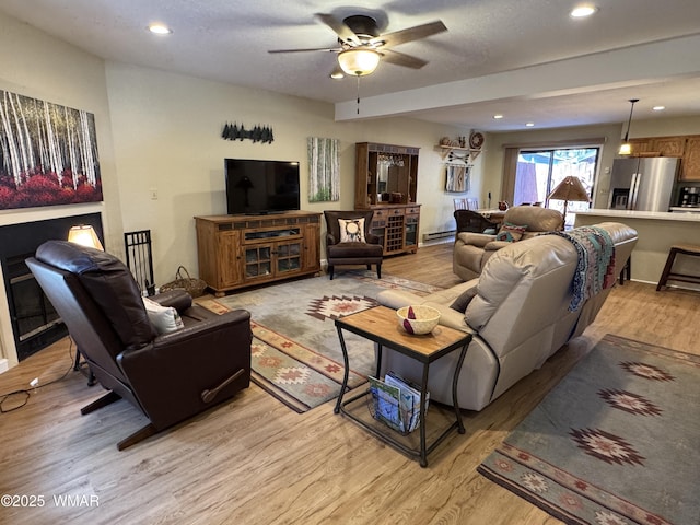 living room with ceiling fan, light wood-type flooring, and recessed lighting