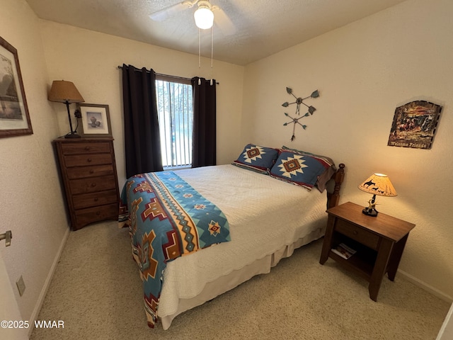 carpeted bedroom with a ceiling fan and baseboards