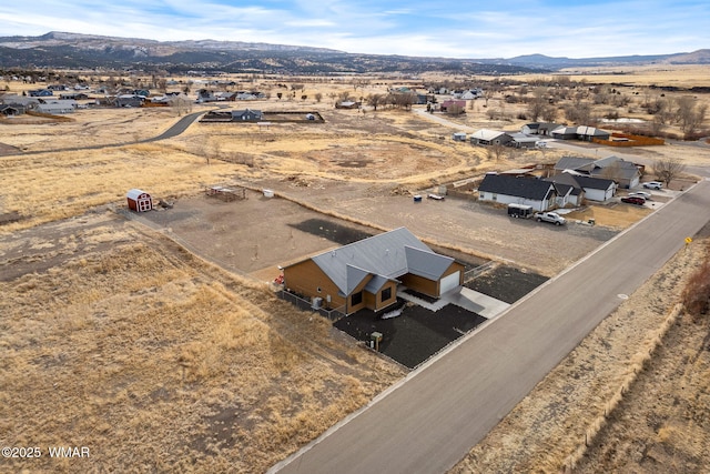 birds eye view of property with a mountain view