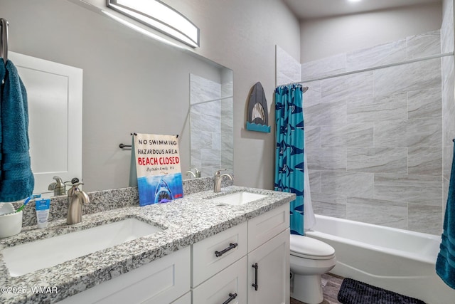 bathroom featuring double vanity, shower / tub combo, toilet, and a sink